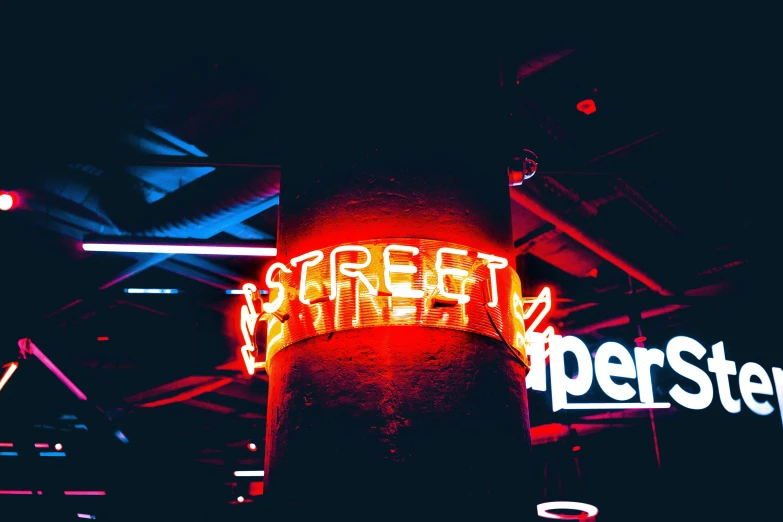 a bright sign advertising street fair lite up