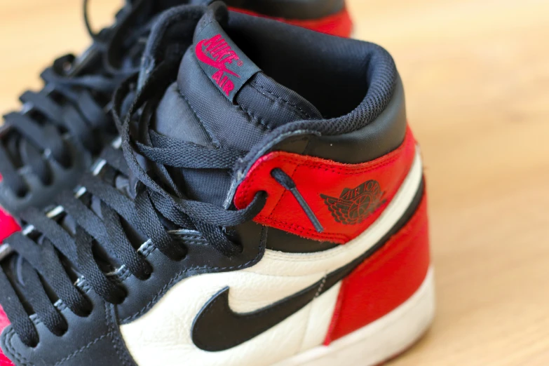 the nike air jordan sneakers are red, white and black