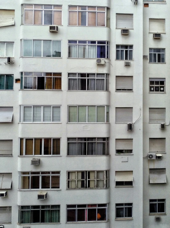 multiple windows with different shapes and sizes on an office building