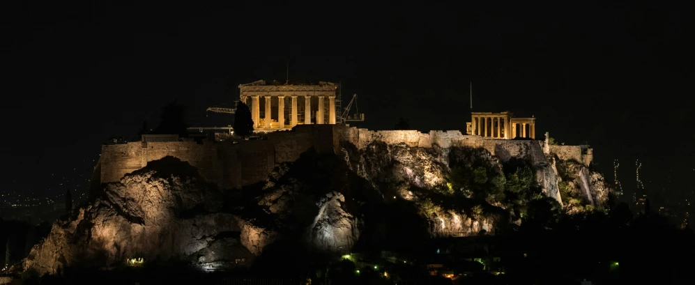 a castle illuminated up at night with the lights on