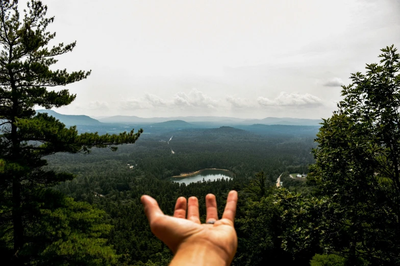 a man with his hand up towards the sky