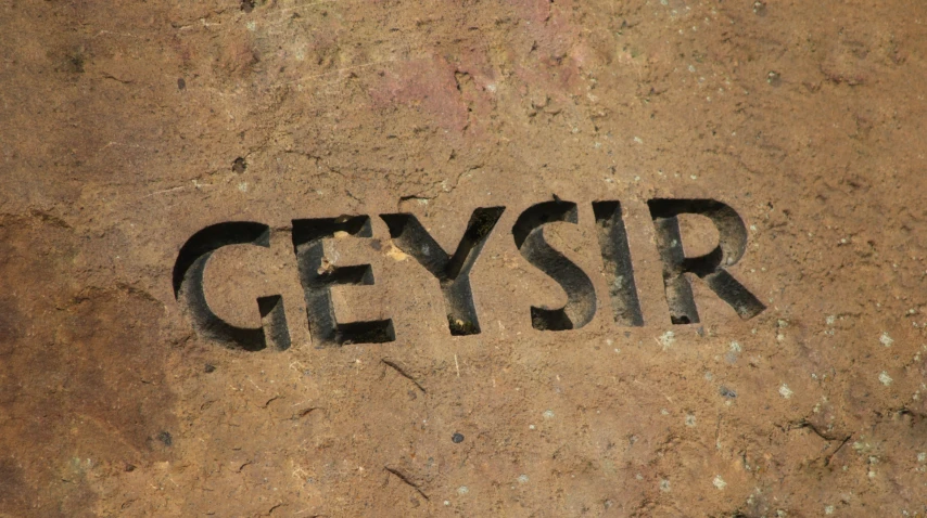 the word geysir is in a rock formation