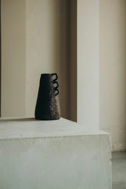 a vase is sitting on a shelf in the middle of a room