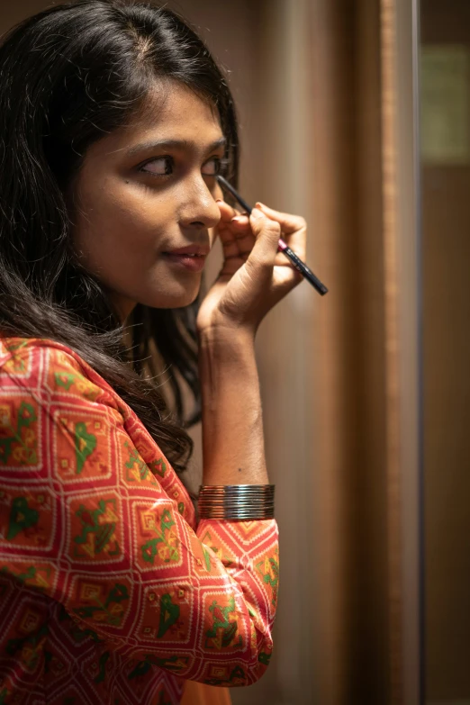 a woman holding a pen in her left hand