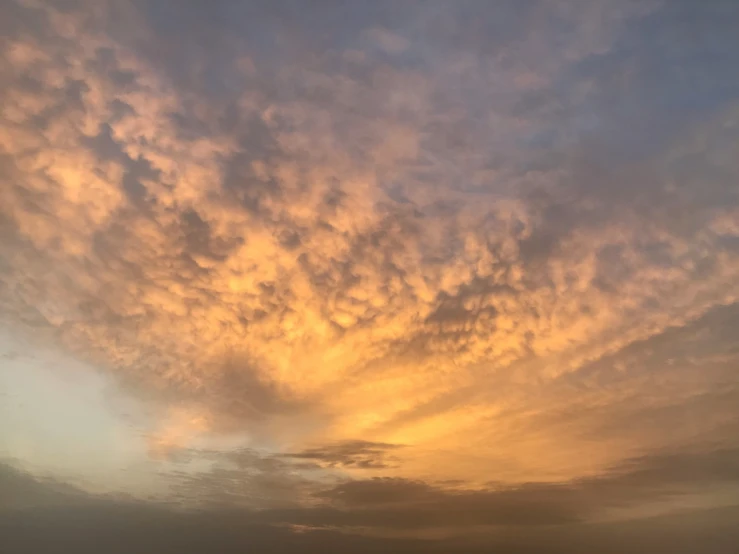 a person standing on the beach during a sunset