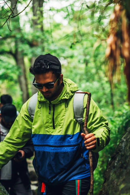 a man with a backpack walks along a trail through the forest