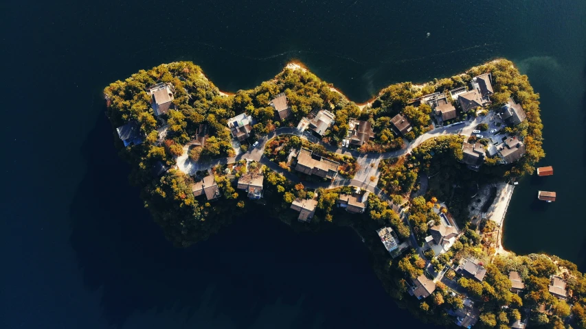 an island that has some houses and boats in it