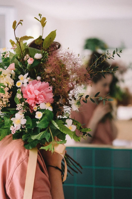 a woman carrying a bouquet of flowers on her back