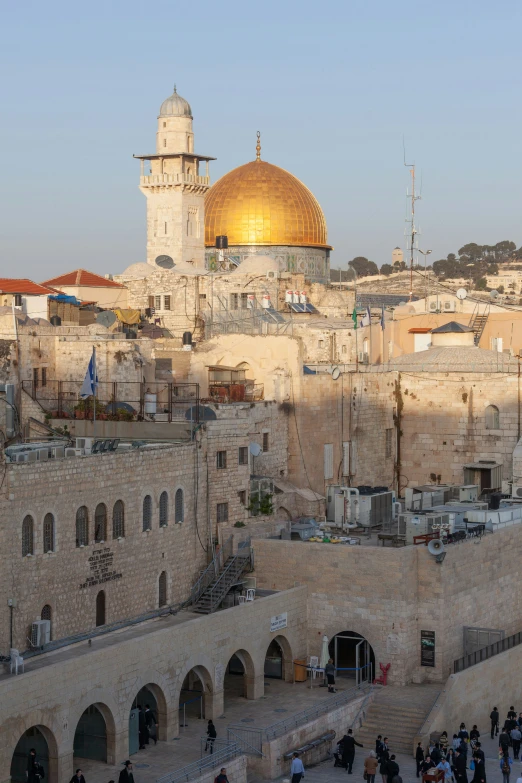 an aerial view shows the dome of a muslim shrine and several archways