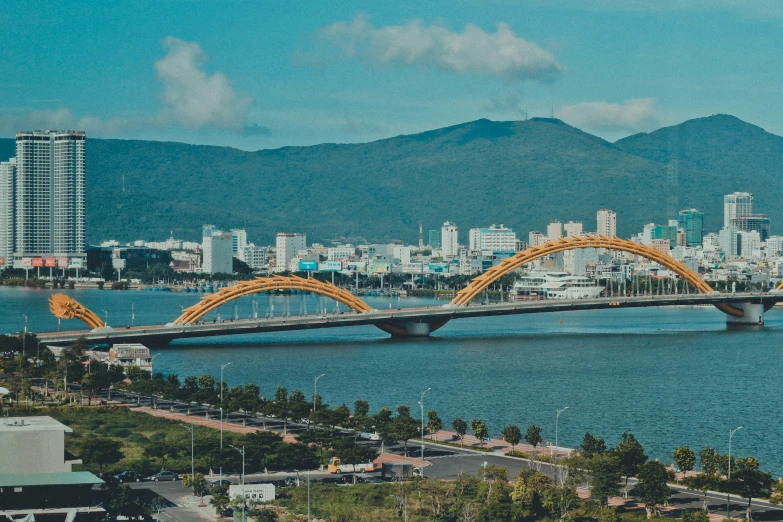 a long bridge over a large lake near a city