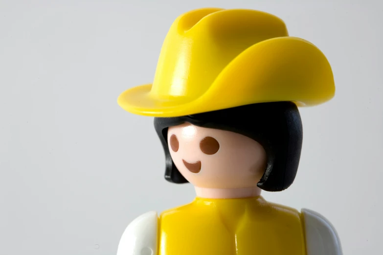 a lego toy has a yellow and black helmet