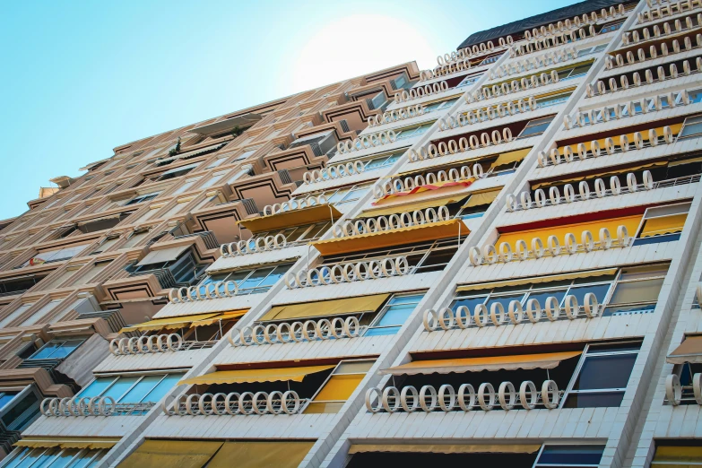 colorful balconyed building with balconies against a blue sky