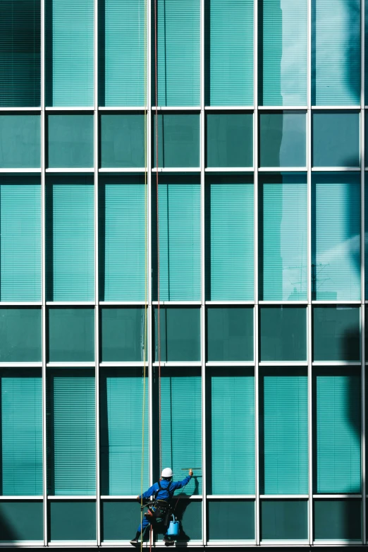 a window cleaner doing window cleaning on a tall building