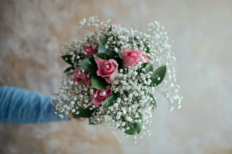 someone is holding a bouquet with pink and white flowers