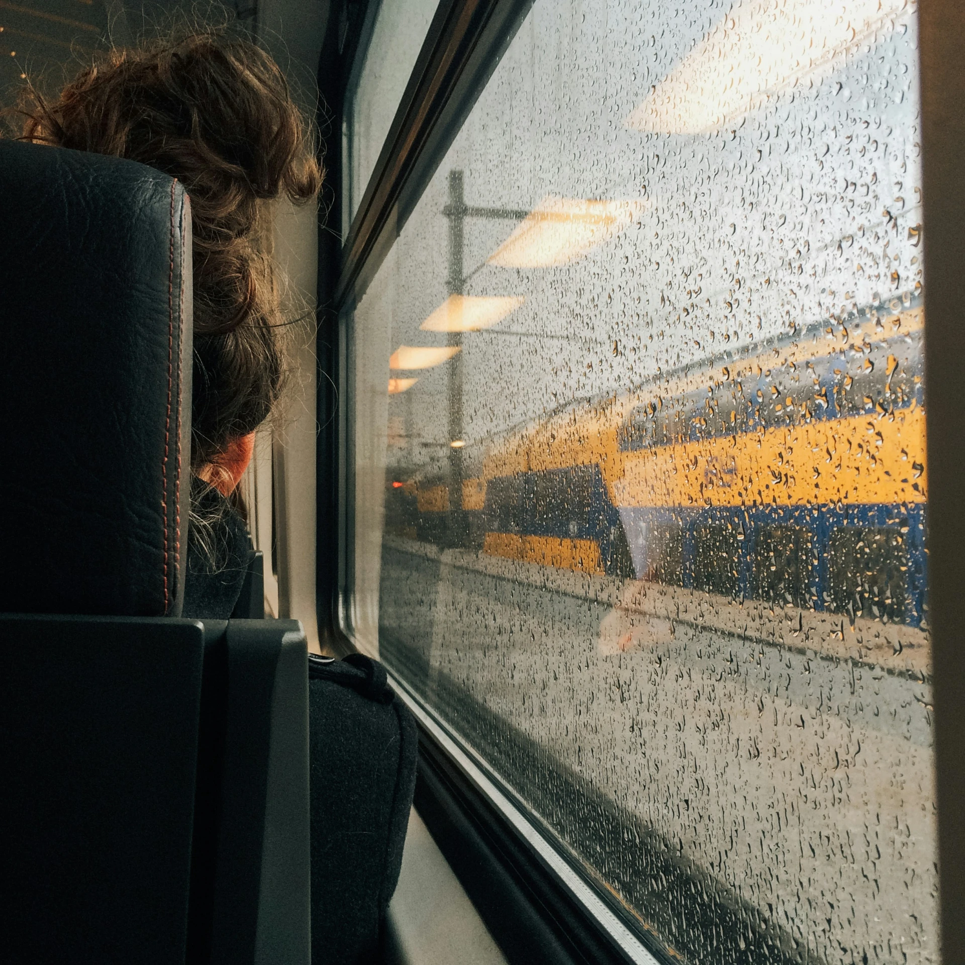 the woman is looking out of a train window