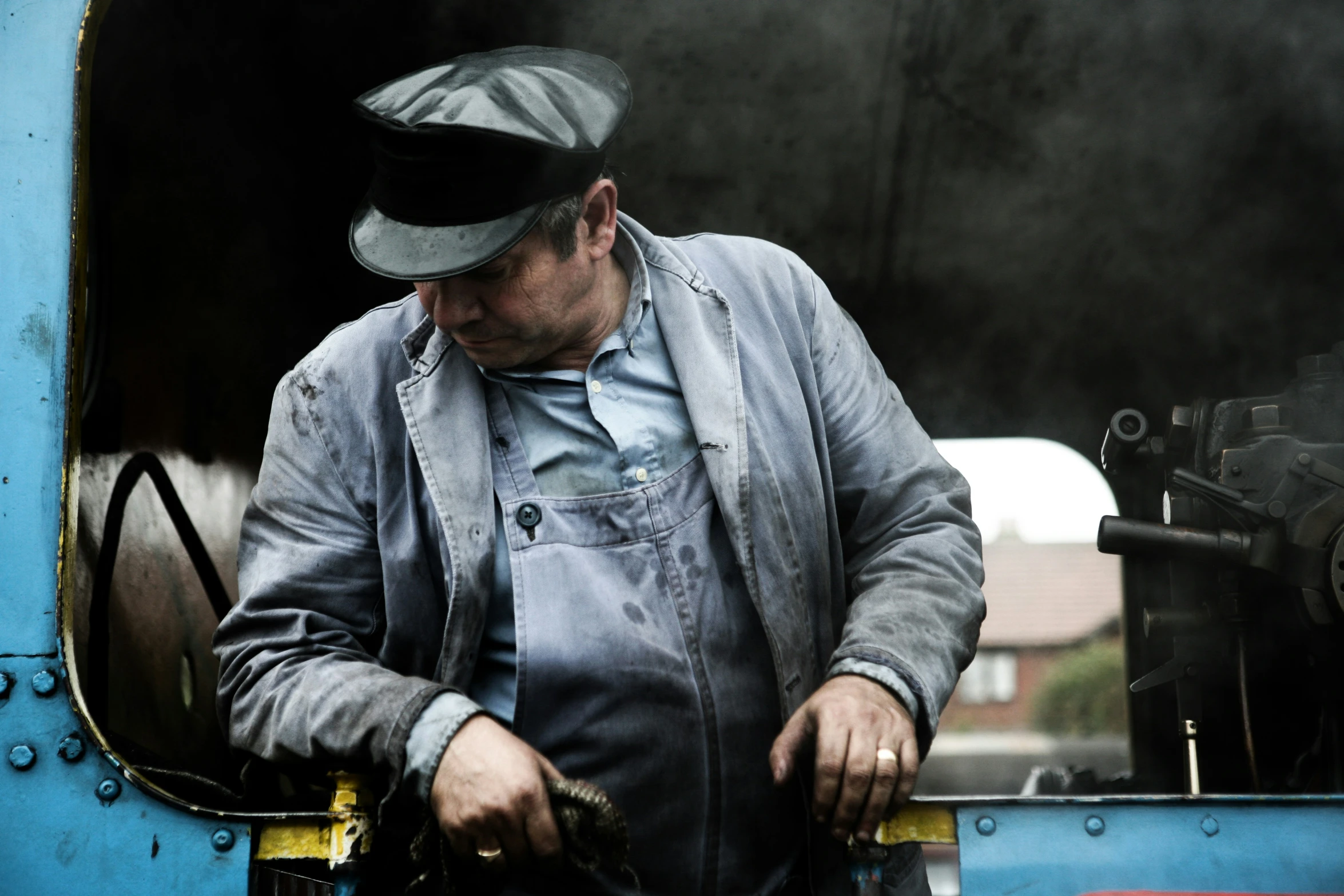 a man works on a piece of equipment that is in a machine shop