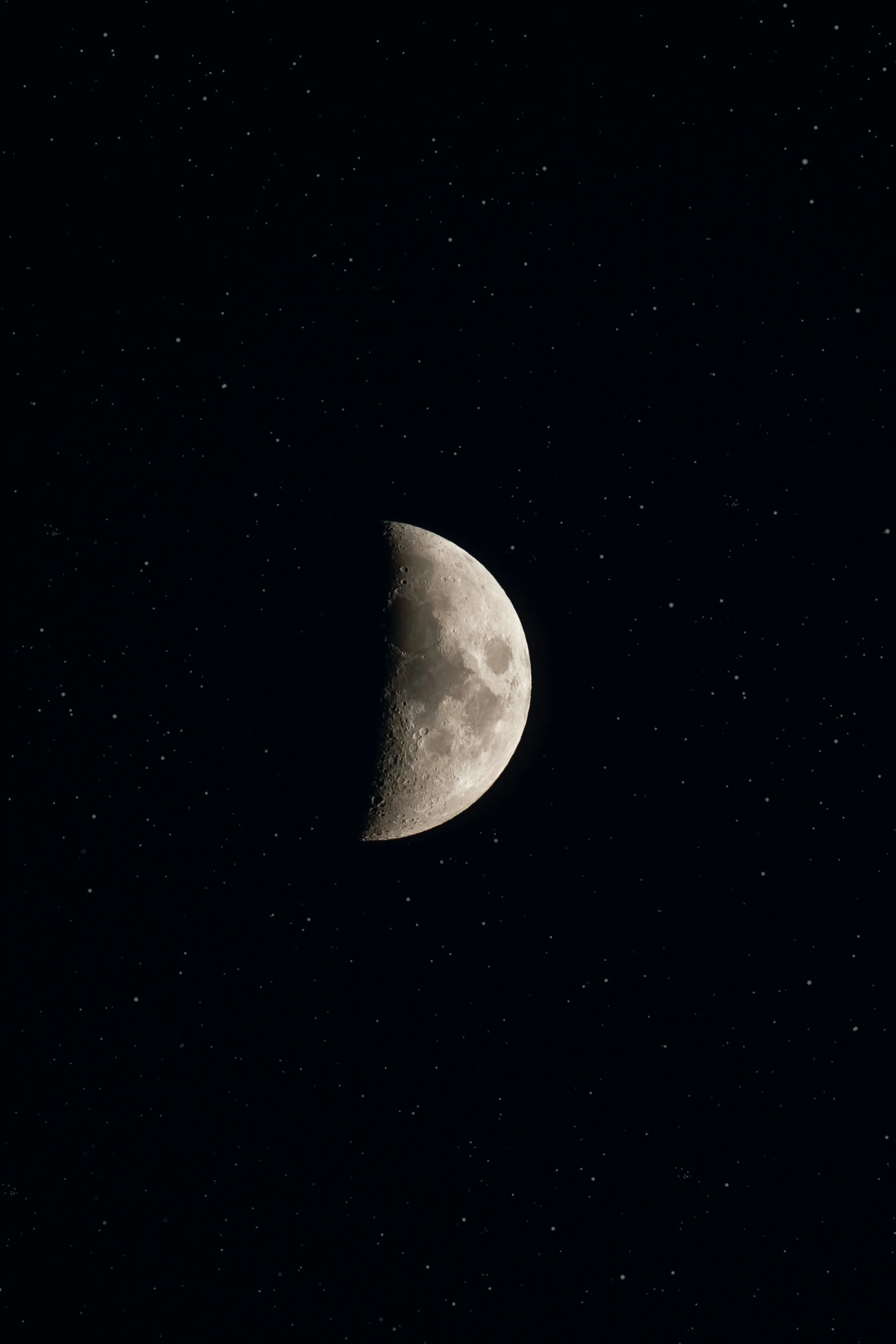 the half moon shining with the dark background