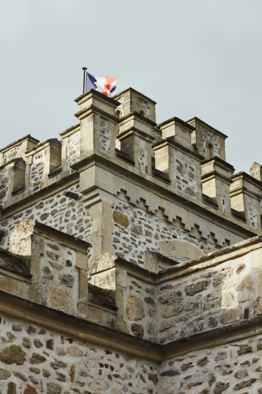 an old stone building with a canadian flag on top