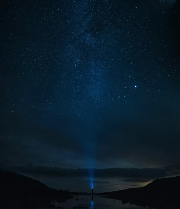 blue star filled sky with mountains and clouds