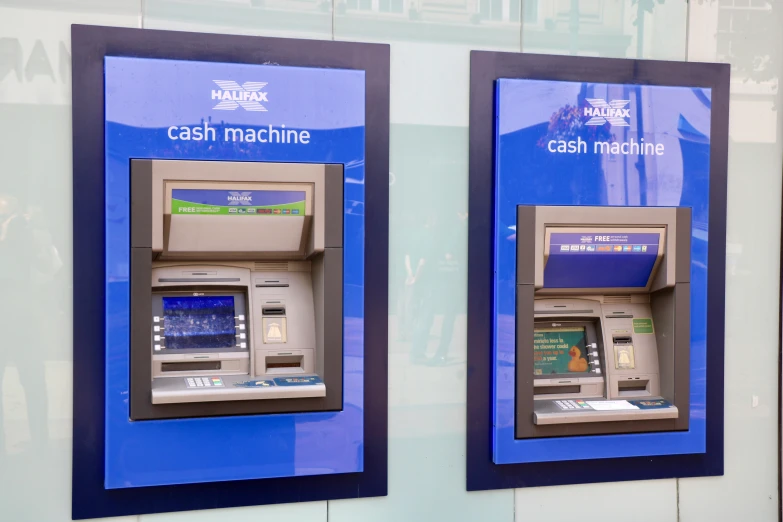 a blue sign reading cash machine and some people in the background