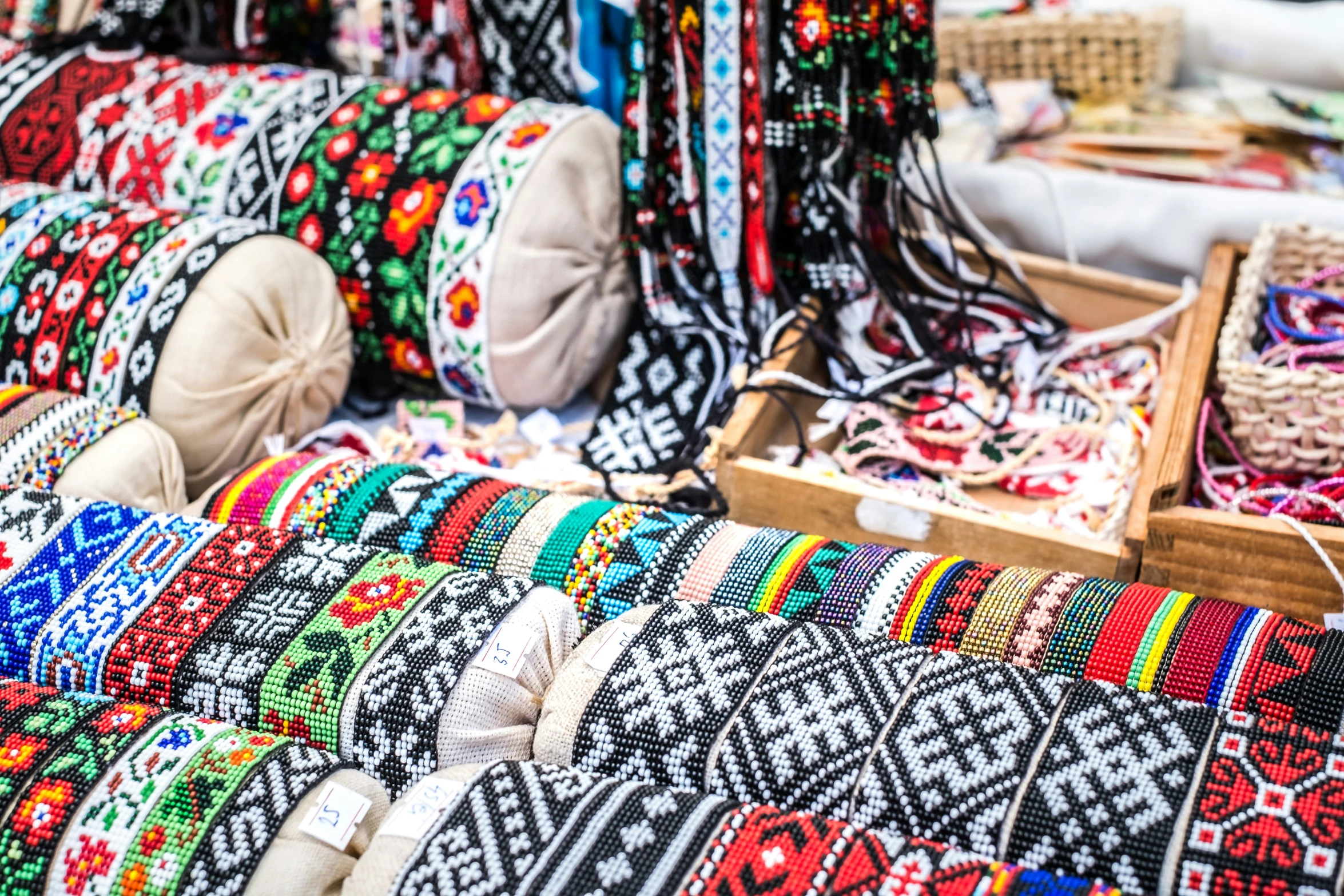 an open area with colorful handwoven fabrics and rugs