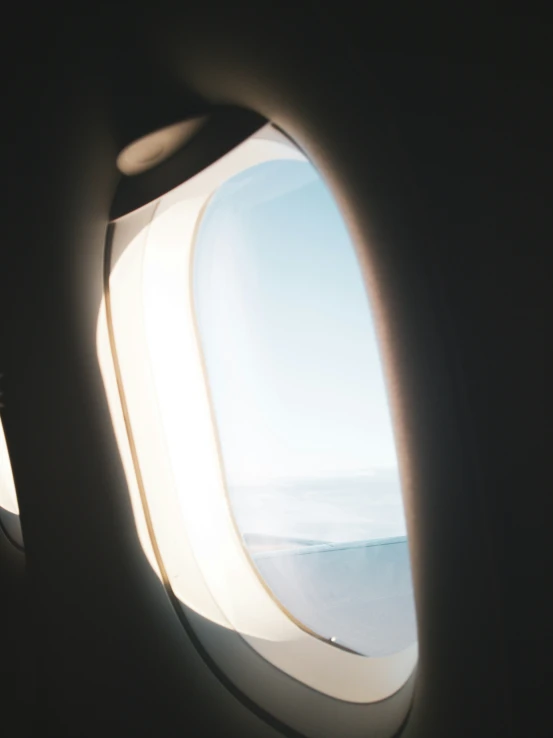 the view out of an airplane window shows a plane wing