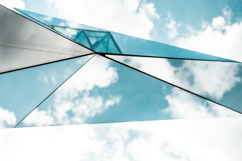 a large glass structure with a sky in the background