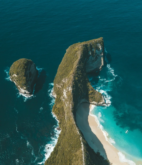 two rocks sticking out of the water in an ocean