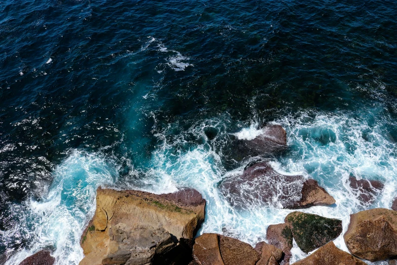 ocean waves hitting the shoreline of rocky coastline