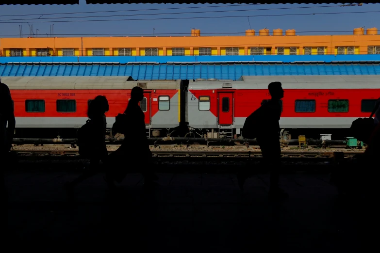 people are standing in the dark at a train station