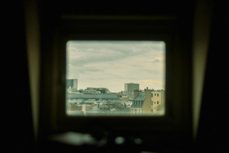 a view of a city with buildings as seen from a window