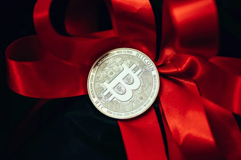 the medal is displayed on a red satin ribbon