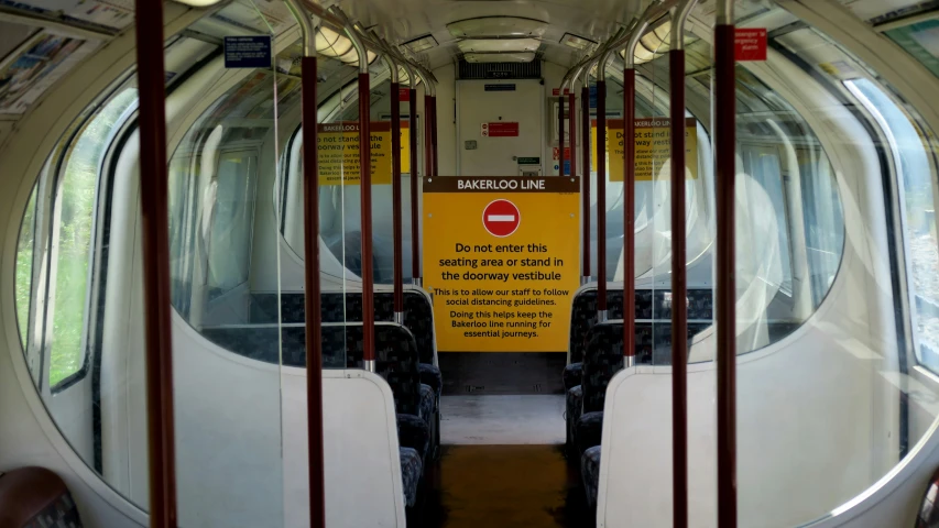 inside an empty subway car with signs on the doors