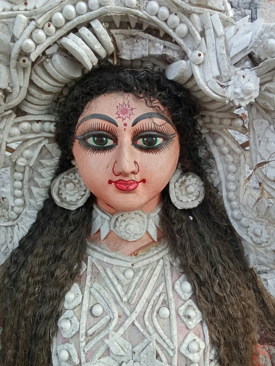 an intricately dressed girl with large earrings
