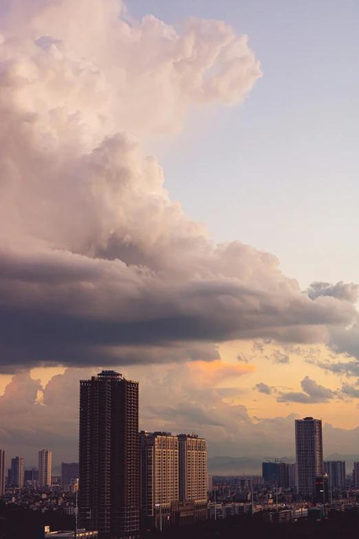 clouds in the sky above city buildings and water