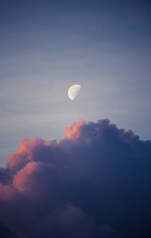 a very pretty moon seen through some clouds