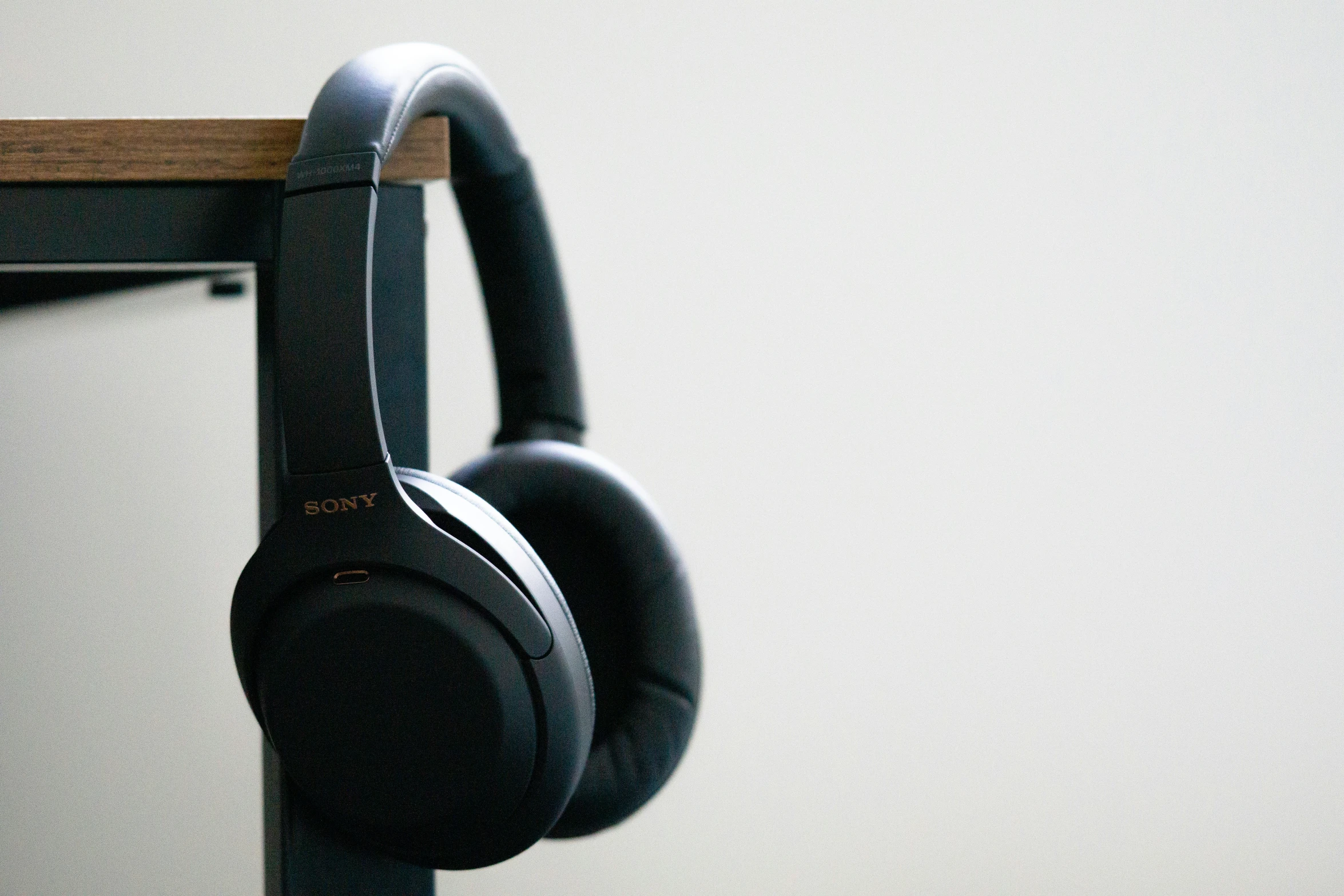 headphones resting on a shelf near a wall