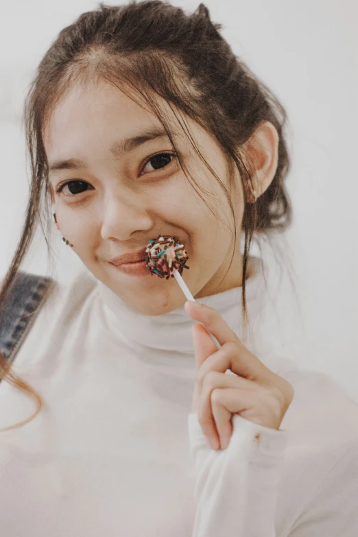 a girl is brushing her teeth with a toothbrush