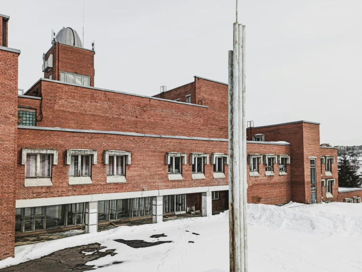 the building in front of the building is completely covered in snow