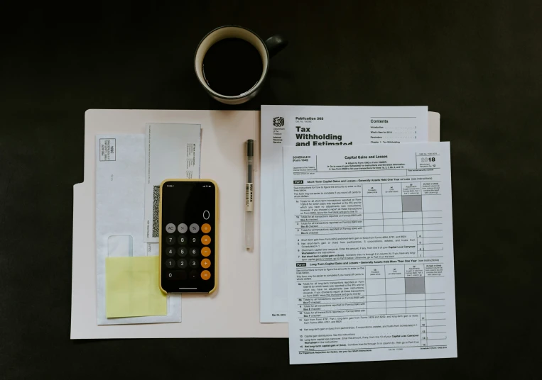 a couple of receipts and a cellphone on a table