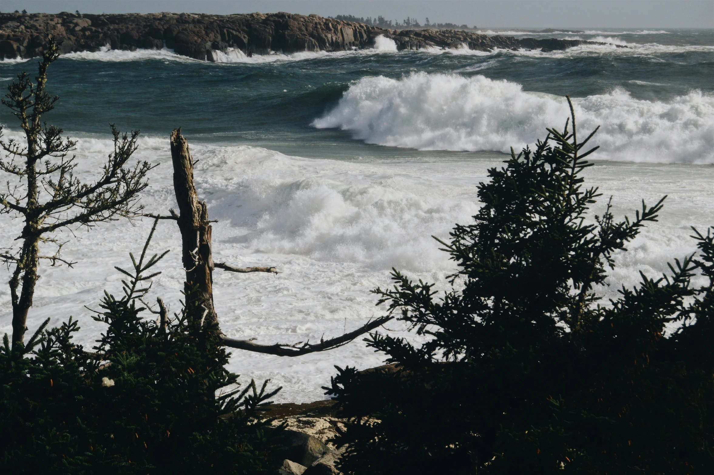 a view of some waves crashing on the beach