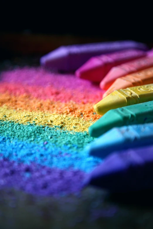 a row of multicolored crayons laying side by side