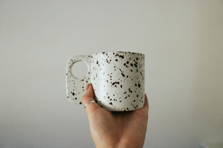 a woman's hand holding a coffee cup