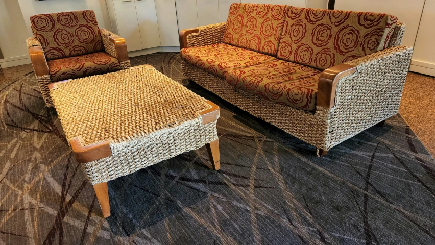 a living room with chairs, ottoman and coffee table