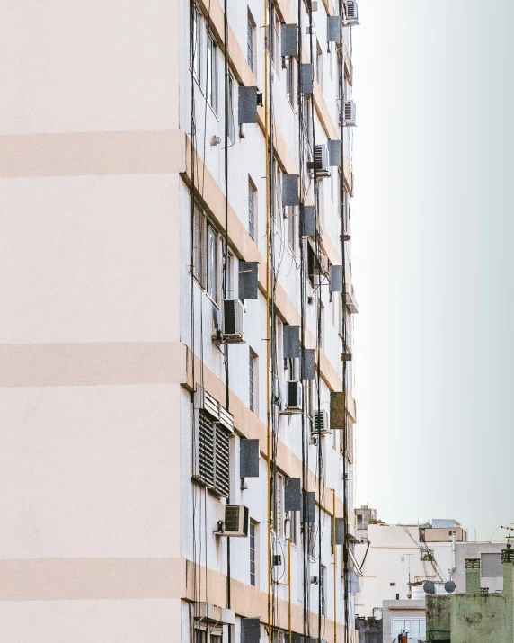 an apartment building with several windows has a street sign in front