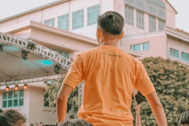 a man is walking with a crowd behind him