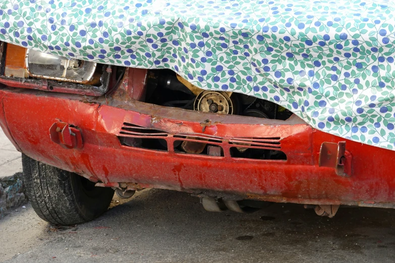 the hood on the car is covered with an abstract blanket