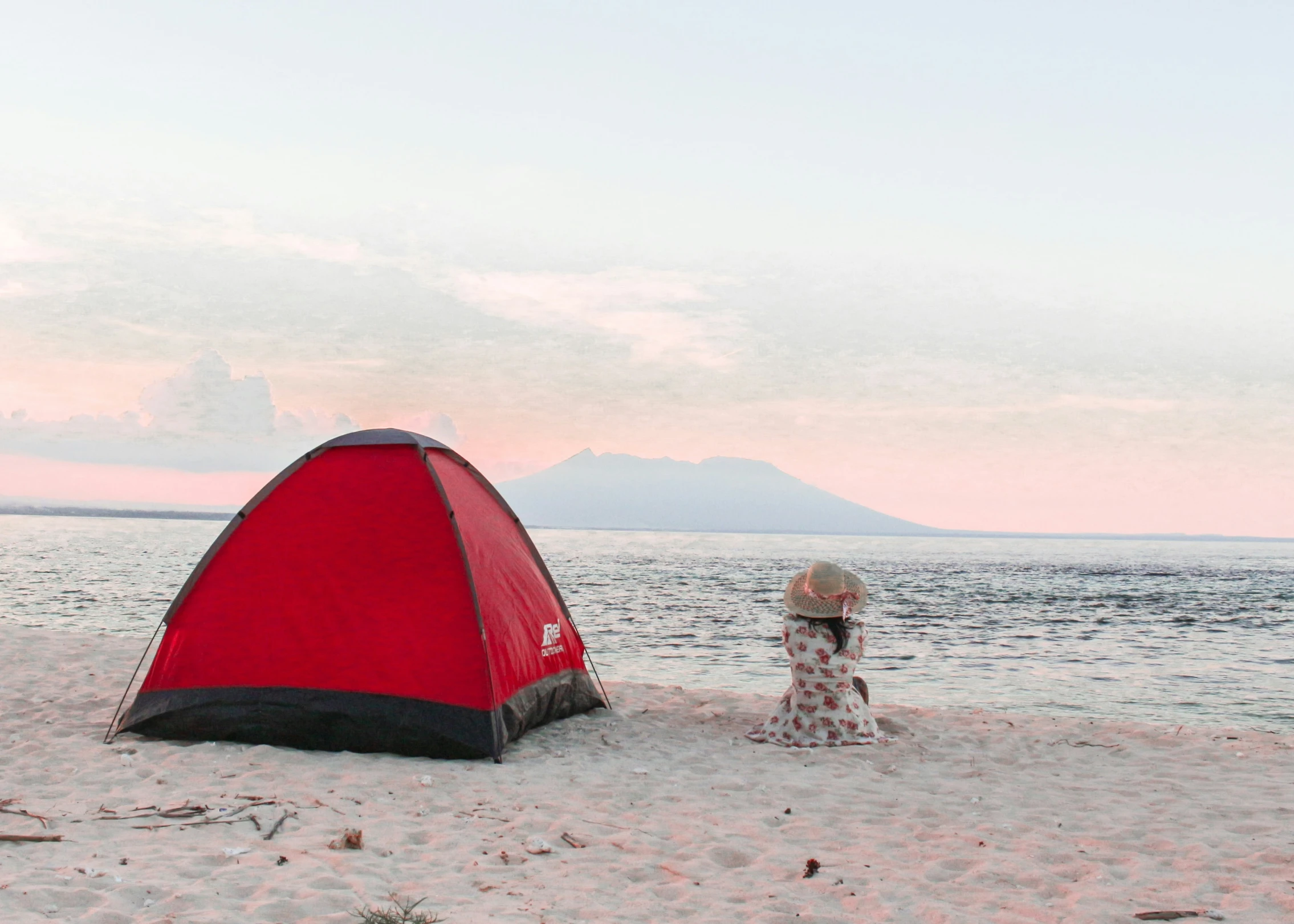 a girl on the beach with a tent