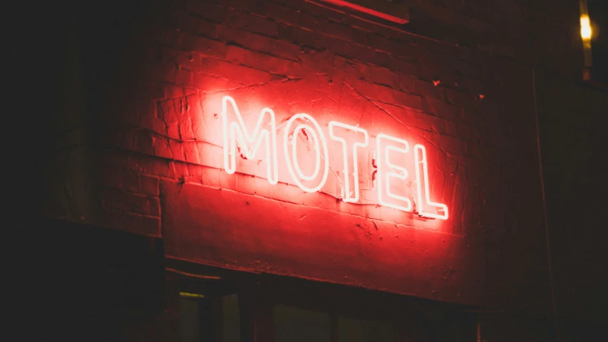 a motel sign that reads the word el illuminated in red