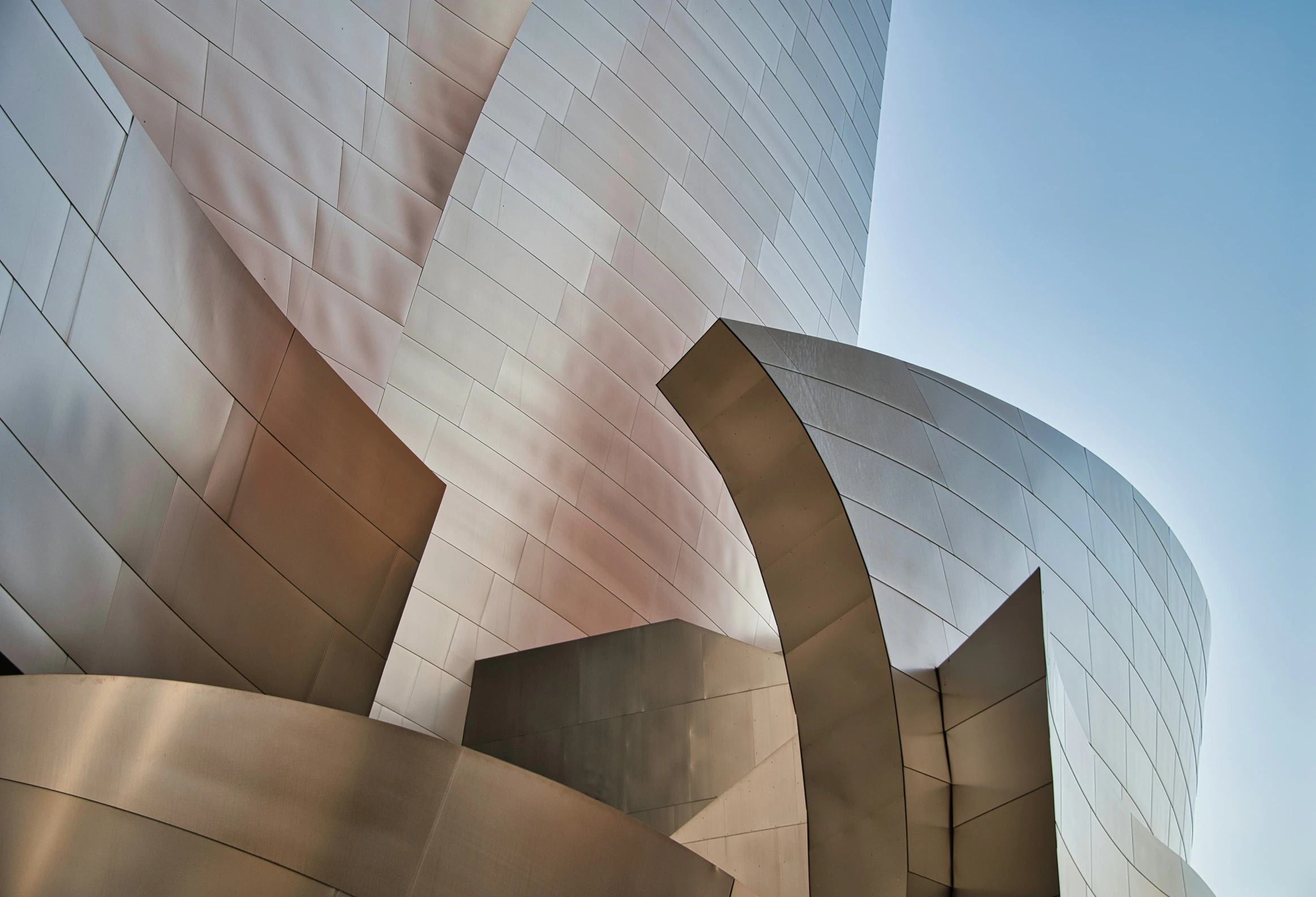 the side of a large, modern building with curved concrete walls